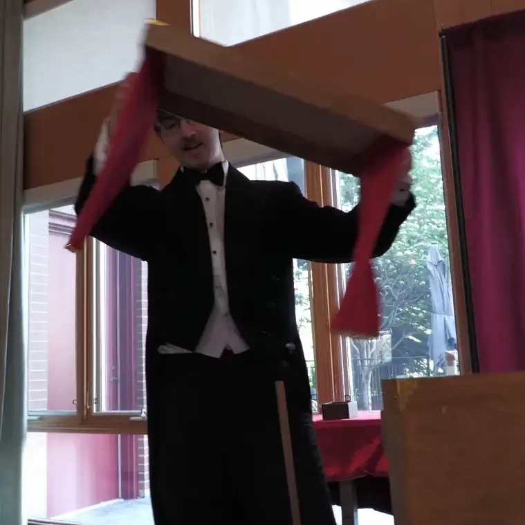 Magician sets up table for Charity Event